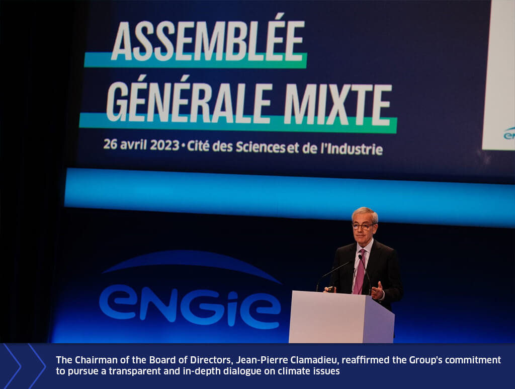 Jean-Pierre Clamadieu speaking at a podium during ENGIE’s General Meeting, with a large screen displaying the event title and date in the background.