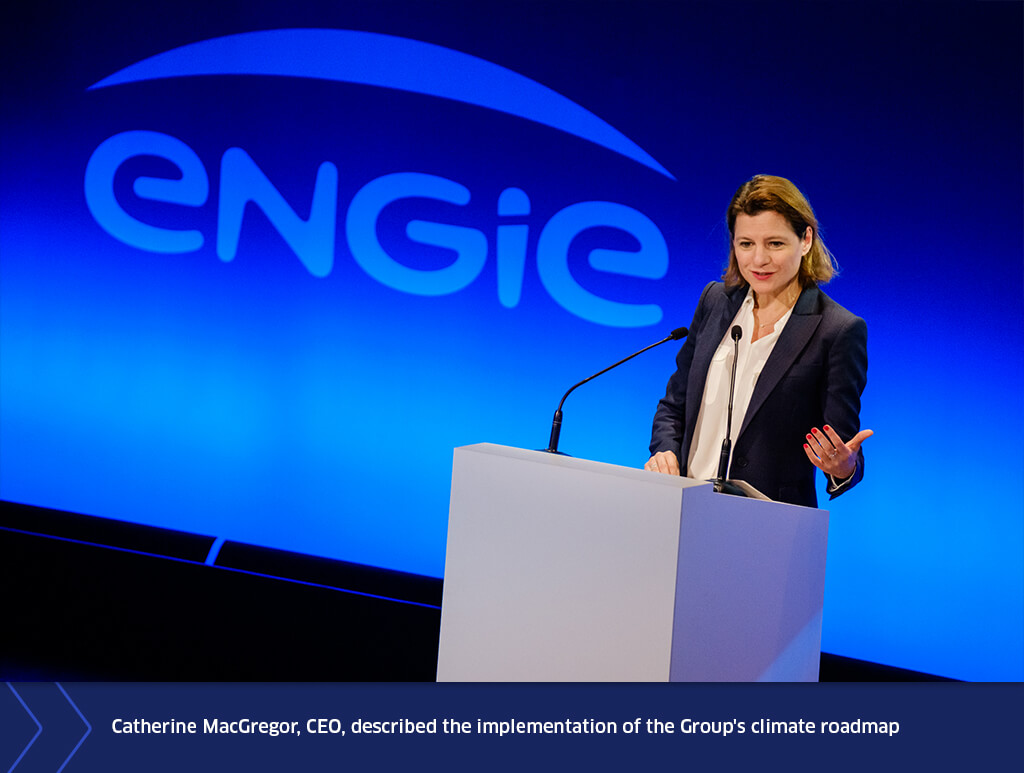 Catherine MacGregor speaking at a podium during ENGIE’s General Meeting, with the ENGIE logo displayed on a blue-lit background behind her.
