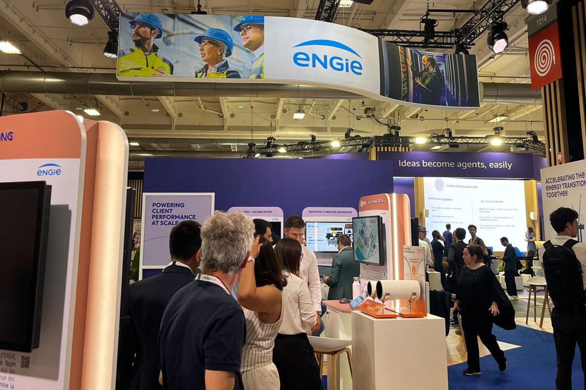 ENGIE booth with visitors at a technology exhibition, digital screens and banners visible