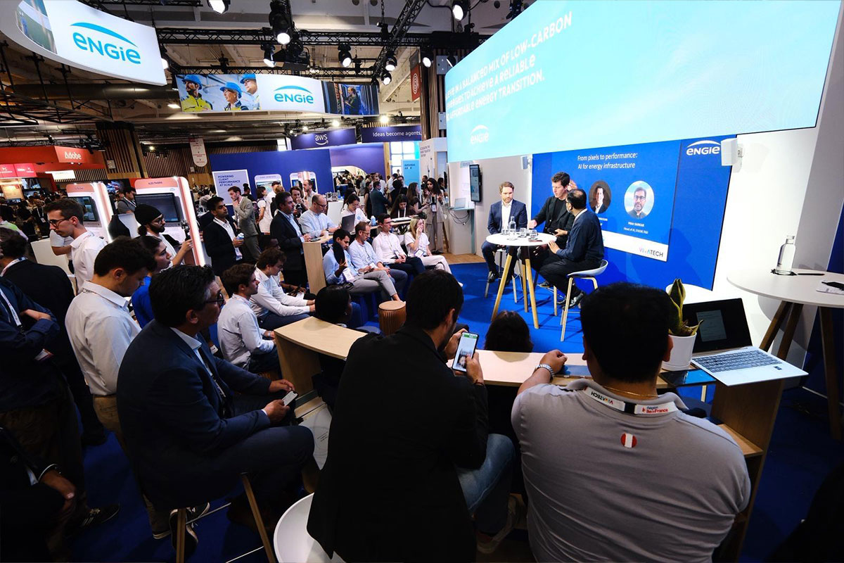 Panel discussion at Engie booth during a tech conference with audience and speakers on stage